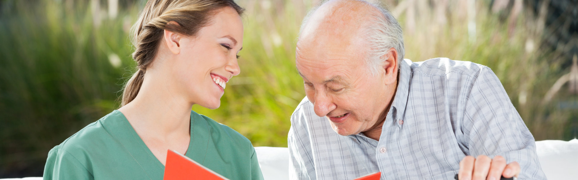 nurse and elderly woman looking at the folder